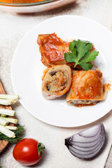 Stuffed cabbage rolls with mushrooms cut into slices on a plate. Stuffed cabbage rolls with parsley. Traditional Ukrainian cuisine. Lean dishes. Golubtsi is a dish of Ukrainian cuisine