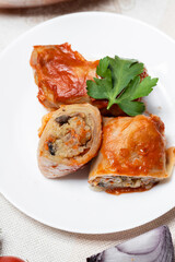 Stuffed cabbage rolls with mushrooms cut into slices on a plate. Stuffed cabbage rolls with parsley. Traditional Ukrainian cuisine. Lean dishes. Golubtsi is a dish of Ukrainian cuisine