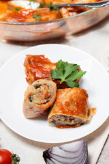 Stuffed cabbage rolls with mushrooms cut into slices on a plate. Stuffed cabbage rolls with parsley. Traditional Ukrainian cuisine. Lean dishes. Golubtsi is a dish of Ukrainian cuisine