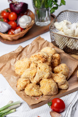 Cauliflower fries, lean dish, cauliflower in batter. Healthy fast food. Low-calorie food fries. Cabbage, tomatoes. Deep fryer. High quality photo.