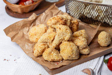 Cauliflower fries, lean dish, cauliflower in batter. Healthy fast food. Low-calorie food fries. Cabbage, tomatoes. Deep fryer. High quality photo.