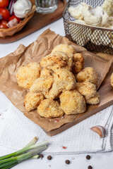 Cauliflower fries, lean dish, cauliflower in batter. Healthy fast food. Low-calorie food fries. Cabbage, tomatoes. Deep fryer. High quality photo.