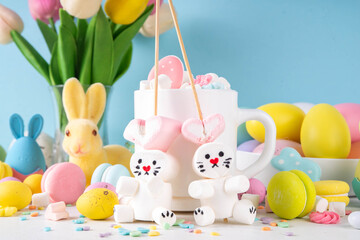 Easter holiday  hot chocolate with funny bunny rabbits creative made with marshmallows, greeting card, child morning party invitation, Easter hot drinks menu background