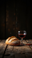 Obraz premium A Christian communion setting with a loaf of bread and a glass of wine on a rustic table.