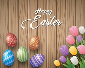 Happy Easter with decorated eggs and flowers above wooden brown background