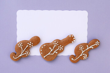 Romantic decorated gingerbread cookies in a shape of guitar and treble clef, white space for text....
