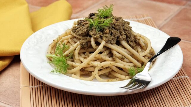 bucatini pasta with sardines - traditional recipe of Sicilian cuisine - closeup
