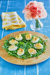deviled eggs on a bed of arugula