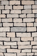 Obraz premium Stone Brick Wall Texture Background with Weathered Surface and Neutral Tones