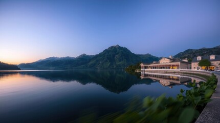 Fototapeta premium Lake Reflections at Dusk with Building and Mountain Scenery View