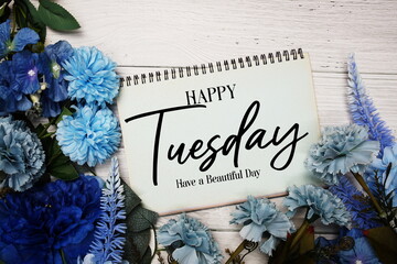 Happy Tuesday Have a Beautiful day text with blue flowers bouquet decoration on wooden background