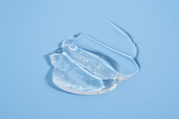 The texture of a cosmetic gel on a blue background.