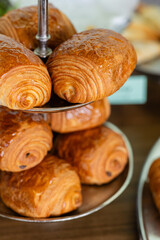 two tier platter of buttery chocolate croissants being served at brunch event