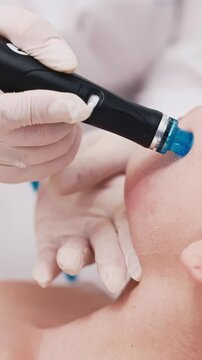 Close-up Hydrofacial treatment. Extraction, exfoliation, infusion, peel, hydration. Showcase effective skincare with rejuvenating anti-age treatment, advertising. Vertical footage