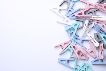 Set of plastic clothespins on white background