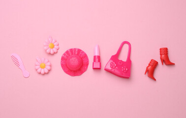 Women doll accessories on pink background. Flat lay