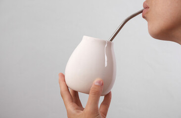Woman drinking Mate with bombilla and calabash
