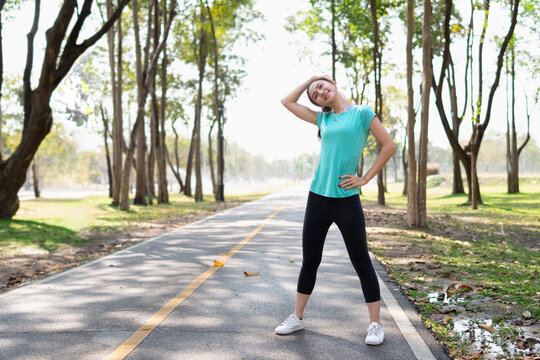 A woman is stretching her neck doing exercises for health and relaxation.