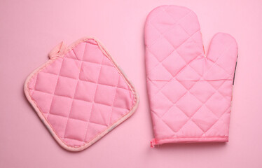 Kitchen gloves for baking on pink background