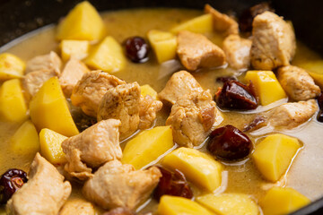 Cholent with potatoes, onions, meat, spices and herbs is stewed in a frying pan