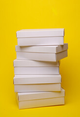 Stack of White cardboard boxes on a gray background