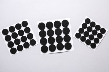 Felt protective circle pads for furniture on gray background