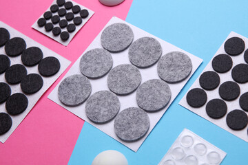 Felt protective circle pads for furniture on pink blue background