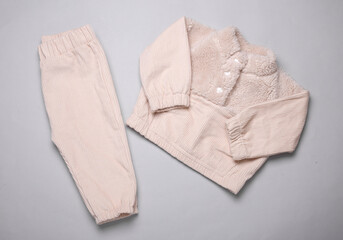 Children's corduroy sweater and pants on a gray background