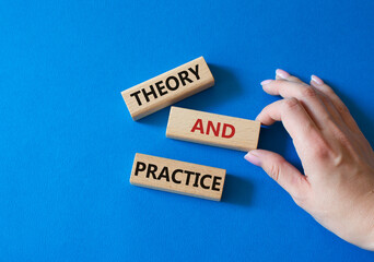 Theory and Practice symbol. Concept word Theory and Practice on wooden blocks. Businessman hand. Beautiful blue background. Business and Theory and Practice concept. Copy space