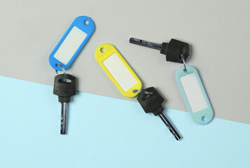 Plastic id tags with keys on pastel background