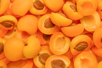 Ripe juicy orange apricots slices fruit background.