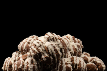 Profiteroles with coconut cream on a black background.