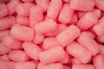 Pink and white box filler as a background. Top view.