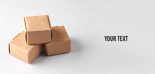 Parcel cardboard craft boxes on a gray background. Your text, copy space for information