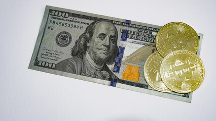 Bitcoin Crypto currency on stacked 100 Dollar Banknotes. Cryptocurrency and United States Dollar Money on white Background.