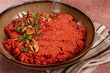 Mahammara red pepper sauce, with walnuts, and sprigs of fresh microgreens, homemade, no people,