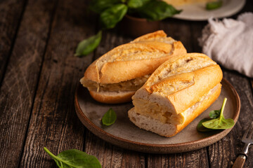 Spanish potato omelette sandwich. Typical Spanish food, Bocadillo de tortilla espanola very popular snack in Spain on white rustic background