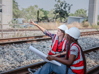 New staff training, engineers discuss with team to work on construction site, railway project, two...