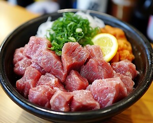 Fresh tuna sashimi with lemon, onion, and tobiko.