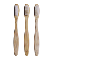 Eco-friendly bamboo toothbrushes arranged neatly on a white surface for sustainable dental care options