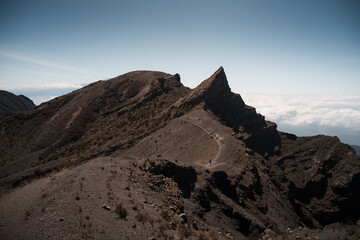 Hikers walking up socialist peak on mount meru in arusha national park, tanzania