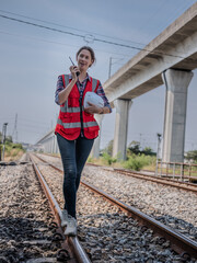 Engineer inspecting the tracks, walking on the railway during construction survey , train switches and inspecting work at the railway station.