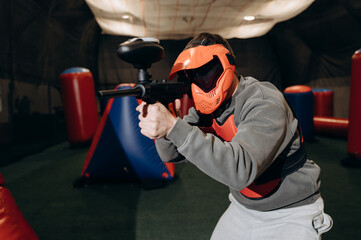 The masked player slowly takes aim, holding the gun with both hands. He calculates the angle of...