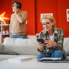 cheerful mature woman use cellphone for contactless payment bills