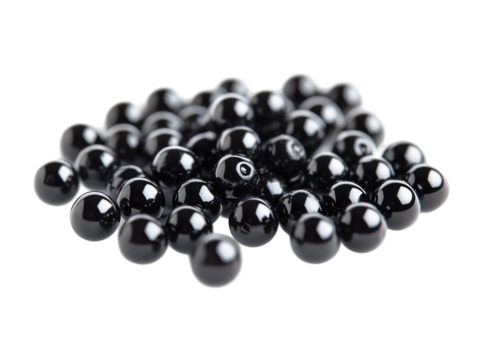 This image shows many small, shiny, black spheres, possibly tapioca pearls or similar ingredients.