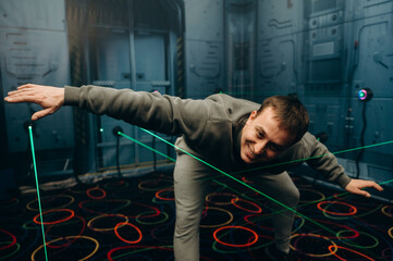 The player carefully crosses the room, keeping his balance and avoiding touching the lasers. The...
