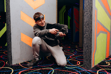 The player stands in a fighting stance, holding a laser blaster. His pose shows confidence in his...