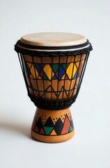 A small wooden drum with black wire borders and colorful patterns on the face, placed against a white background