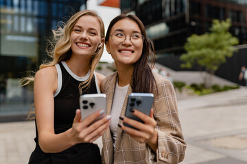 Fototapeta premium young pretty women walking outside in street doing business