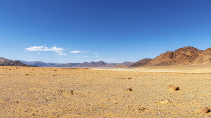 Fototapeta premium Dramatic panorama of Namib Desert showcasing vast sandy terrain and mountains